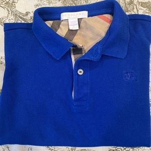 Children Blue Polo style Burberry shirt in a size 6.